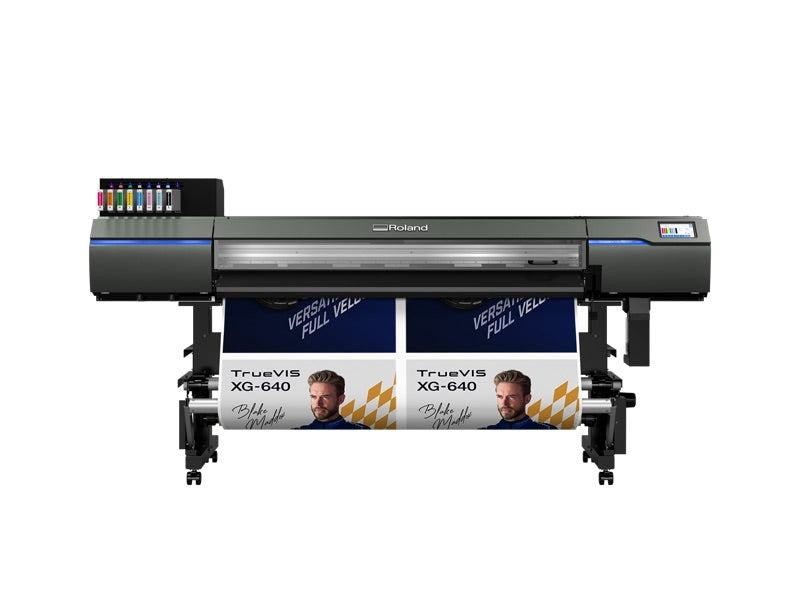 XG-640 printer alongside a large-format poster it produced